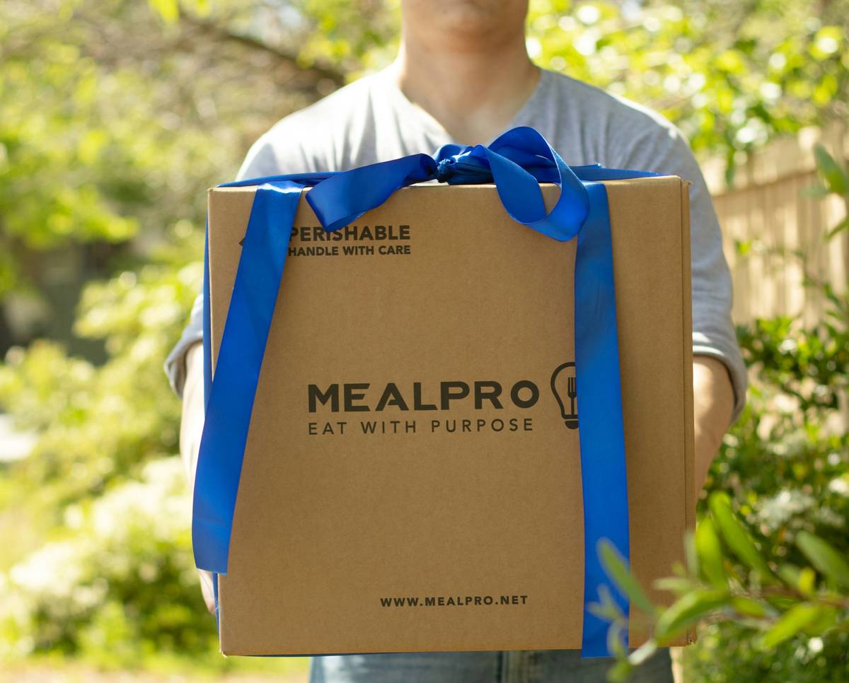 what is a meal delivery service: fresh ingredients and prepared meals in eco-friendly packaging on a kitchen counter